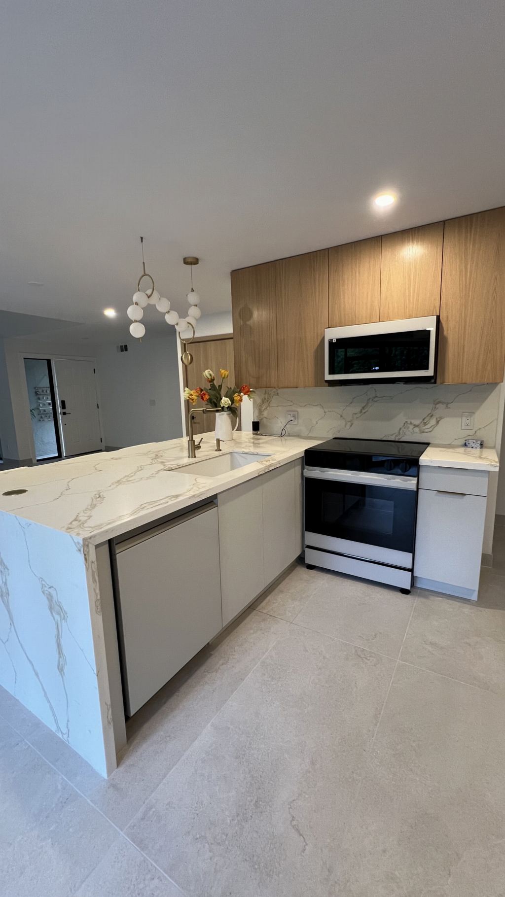 Oak kitchen with marble waterfall and integrated appliances
