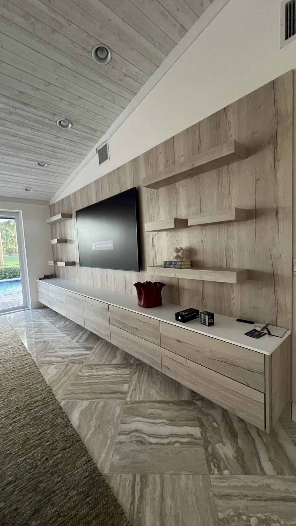 Floating media wall in oak panel