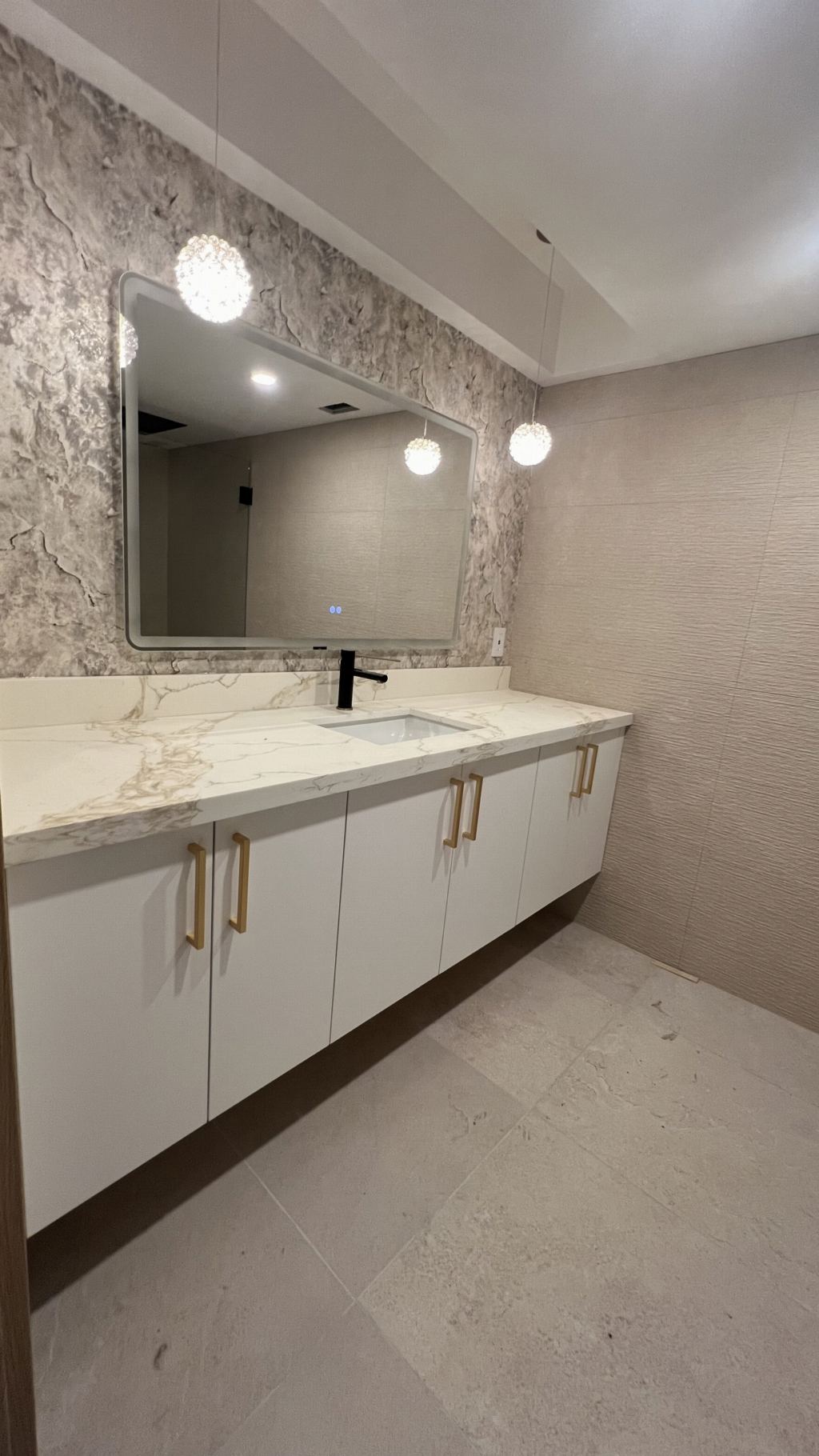 Floating marble vanity with brass pulls